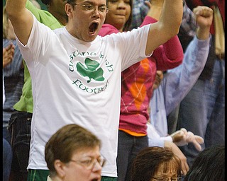 Geoffrey Hauschild|The Vindicator.Arvin Irizarry Sr., of Youngstown, cheers as his daughter Aurielle plays with her fellow Ursuline teamates during the fourth quarter at Mineral Ridge High School on Saturday afternoon.