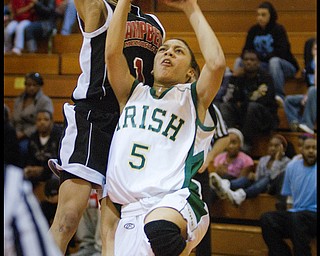 Geoffrey Hauschild|The Vindicator.Ursuline's Aurielle Irizarry (5) tries for a layup but is ultimately fouled byCampbell's Tashira Uceta (1) during the fourth quarter at Mineral Ridge High School on Saturday afternoon.