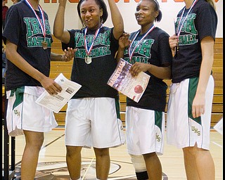 Geoffrey Hauschild|The Vindicator.Ursuline's Dominique Jenkins (15), Keneesha Tensley (11), Jasmine Brown (20), and Allison Naples (31) celebrate and pose for photographs following the game at Mineral Ridge High School on Saturday afternoon. After winning, the team wore shirts in support of Uruline's boys basketball player Jordan Dubose (45) who was recently diagnosed with a serious illness.