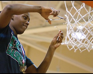 Geoffrey Hauschild|The Vindicator.Courtney Powell (32) cuts off a piece of the net following a victory over Campbell at Mineral Ridge High School on Saturday afternoon. After winning, the team wore shirts in support of Uruline's boys basketball player Jordan Dubose (45) who was recently diagnosed with a serious illness.