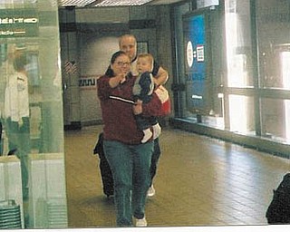 Tom and Andrea McGoogan arrive at Pittsburgh Airport in 2006 from Moscow, Russia, with their son, Nicholas Max. Nicholas sees his new family for the first time..