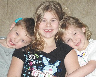 Morgan, 11, Hannah, 8, and Robby, 6, Kist at home last May..