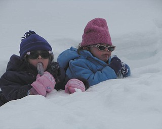 Mia and Carlie Lazazzera taking a break from the snow and enjoying an icicles..