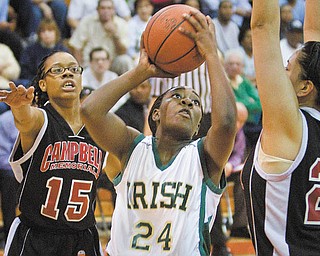 Geoffrey Hauschild|The Vindicator.Ursuline's Briana Curd (24) takes aim while defended by Campbell's Jayaira Grhim (15) and Tiffany Colon (25) during the third quarter at Mineral Ridge High School on Saturday afternoon.