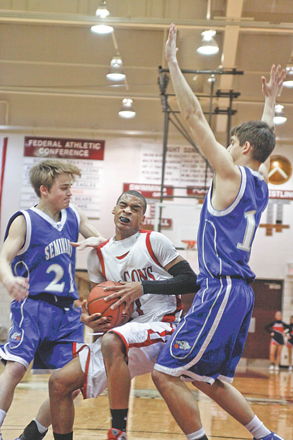 Poland Seminary's Drew Wagner (22) and John Price (15) block Niles Dragon's Saul Vaughn (11) during the first period at Boardman High School, Monday March 8, 2010.