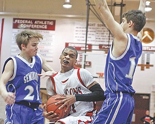 Poland Seminary's Drew Wagner (22) and John Price (15) block Niles Dragon's Saul Vaughn (11) during the first period at Boardman High School, Monday March 8, 2010.