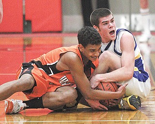 (1) Justin Rota of McDonald and DeShon Pullie battle for the ball during their game Monday night in Struthers.