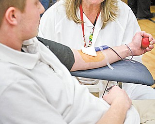 The Red Cross also is involved in the collection and processing of blood products under its Northern Ohio Blood Services Region located in Cleveland. Mary Bee of Braceville, who draws blood, explains the process to Jeff Grope, a sophomore at Lowellville High School, who was donating for the first time at a recent blood drive at the school.