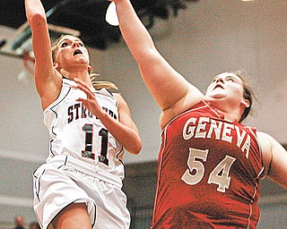 Struthers’ Katelyn Ardale (11) stays out of the reach of Geneva’s Natalie Stanley (54) during first-quarter action in their District II regional semifinal Tuesday at Barberton High School. The Wildcats defeated the Vikings, 50-46.