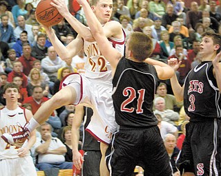 Mooney's Danny Reese (22) negotiates a pass over the heads of Struthers' Nick Ragan (21) and Jake Jakubec (3) during the third quarter of a game at Boardman High School on Wednesday afternoon.