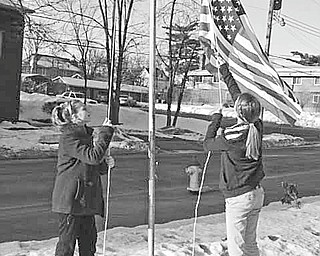 The Vindicator
The sixth-grade class at St. Patrick School in Hubbard has been given the privilege of continuing the tradition of raising the American flag each school day morning. Showing their patriotism by raising the flag March 4 are, from left, Michaela Huber and Concetta Seidler. When classes come to a close in the afternoon, they lower the flag, carefully fold it and put it away for the next day.