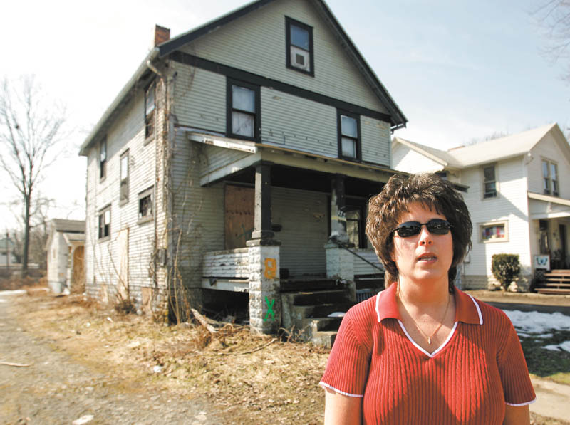Lori Graham, Warren’s Neighborhood Stabilization Program coordinator, said  housing demolitions have continued through the winter, but the pace will pick up as the weather improves. The house behind her soon will experience the wrecking ball.