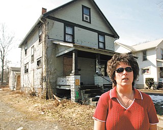 Lori Graham, Warren’s Neighborhood Stabilization Program coordinator, said housing demolitions have continued through the winter, but the pace will pick up as the weather improves. The house behind her soon will experience the wrecking ball.