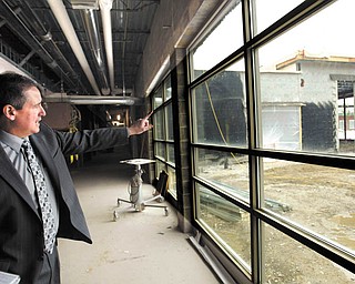Dennis Dunham, superintendent of South Range schools, points out how the media center at the new school complex will be centrally located, making it the center point with easy access for all students. The new school complex on state Route 46, which will house students in kindergarten through grade 12, is expected to be completed in time for the start of the next school year.