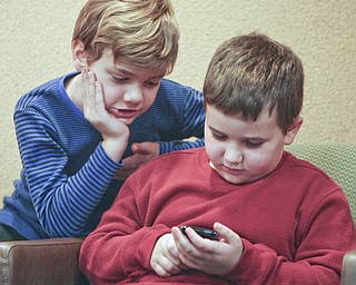 ROBERT K. YOSAY | THE VINDICATOR..techno guru's - as Mathew Rossi 8 of Poland and Santino Angelilli 7 of Struthers ck their hand held computer to help them figure out spellings of the words in the 2010 -77th Vindicator Spelling Bee was held at the Chestnut Room at Kilcawley Center at YSU - 30-