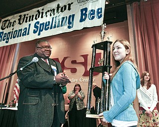 ROBERT K. YOSAY | THE VINDICATOR..congratulating the champion and presenting the trophy Rev. Lewis Macklin applauds Champion - Springfield Elementary Julia Miglets - as the winners in the 2010 -77th Vindicator Spelling Bee was held at the Chestnut Room at Kilcawley Center at YSU - 30-