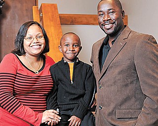 The Clervil family from Florida includes, from left, Jennie; Brian, 5; and Lesly Clervil. They visited the congregation of St. Michael Church in Canfield Sunday to tell their personal experiences with the Haiti earthquake.