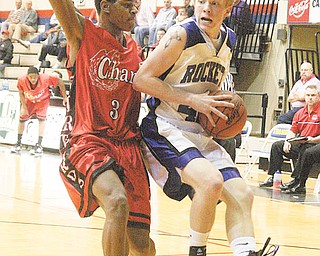 BBALL - Alex Doneyko drives to the hoop as (3) Devonta Brooks plays defense Tuesday night in Canton. - Special to The Vindicator/Nick Mays