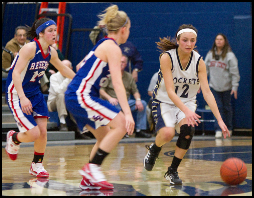 The Vindicator/Geoffrey Hauschild.Lowellville's Taylor Hvisdak (12) drives down court while defended by Western Reserve's Colleen Kennehan (10) and teamate Hannah Mowery (23) during the fourth quarter of a game at Lowellville High School on Monday evening.