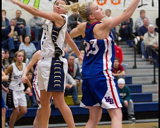 The Vindicator/Geoffrey Hauschild.Lowellville's Ashley Moore (5) and Western Reserve's Hannah Mowery (23) attempt to put their hands on a Lowellville pass during the fourth quarter of a game at Lowellville High School on Monday evening.