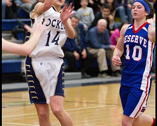 The Vindicator/Geoffrey Hauschild.Lowellville's Emily Carlson (14) throws a pass while pursued by Western Reserve's Colleen Kennehan (10) during the fourth quarter of a game at Lowellville High School on Monday evening.