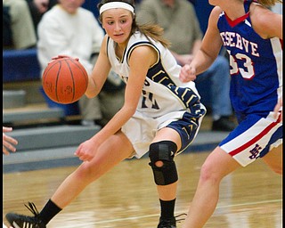 The Vindicator/Geoffrey Hauschild.Lowellville's Taylor Hvisdak (12) changes direction to avoid Western Reserve's Tori Korda (33) during the fourth quarter of a game at Lowellville High School on Monday evening.