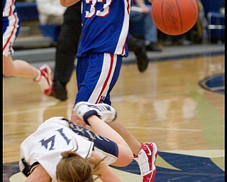 The Vindicator/Geoffrey Hauschild.Lowellville's Emily Carlson (14) takes a tumble on her way to the basket ahead of Western Reserve's Tori Korda (33) during the fourth quarter of a game at Lowellville High School on Monday evening.
