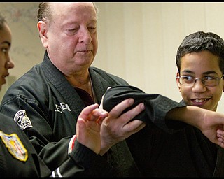The Vindicator/Geoffrey Hauschild.?Todd? Vea (center) gives instruction to Ben Powell (13) (right) and his sister, Heather Powell (17), during a lesson at AE Vea Karate along Belmont on Friday afternoon.