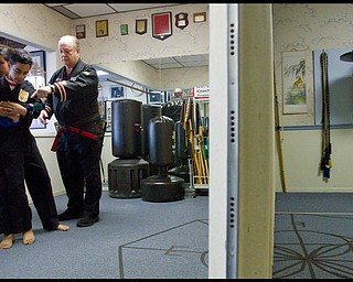 The Vindicator/Geoffrey Hauschild.(Left-Right) Heather Powell (17) and her brother, Ben Powell (13), receive instruction from ?Todd? Vea during a lesson at AE Vea Karate along Belmont on Friday afternoon.