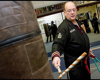 The Vindicator/Geoffrey Hauschild.?Todd? Vea strikes a bag with a __ during a karate lesson at AE Vea Karate along Belmont Ave. on Friday afternoon..