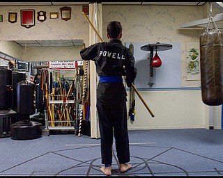 The Vindicator/Geoffrey Hauschild.Ben Powell, 13 of Youngstown, practices with a bo during a karate lesson at AE Vea Karate along Belmont Ave. on Friday afternoon..