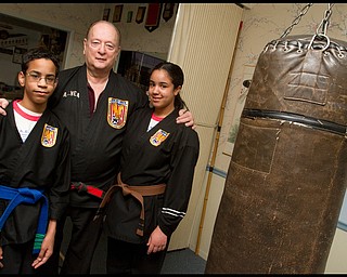 The Vindicator/Geoffrey Hauschild.Ben Powell, 13, ?Todd? Vea, and Heather Powell, 17, pose for a portrait during a lesson at AE Vea Karate along Belmont on Friday afternoon.