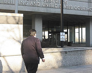 Above, John J. Cafaro, former vice president of the Cafaro Co., enters the federal courthouse in Akron. He was later booked into jail Wednesday for failing to give a federal judge details of his personal finances.