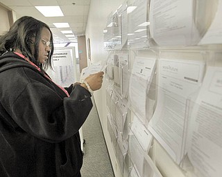 In this photo made March 9, 2010, Damashata Washington looks for work at Work 2 Future, a federally funded job training center, in San Jose, Calif. Companies that hire unemployed workers will get a temporary payroll tax holiday under a bill that easily won final congressional approval Wednesday, March 17, 2010. (AP Photo/Marcio Jose Sanchez)
