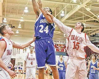 Poland senior Ben Donlow (24) scores a basket against Niles in a Division II tournament game at Boardman High School on March 8. Donlow, who recently surpassed 1,000 career points, leads the Bulldogs against Akron St. Vincent-St. Mary tonight in a regional semifinal at the Canton Memorial Civic Center.