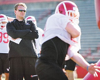 In his first spring practice as YSU’s head football coach, Eric Wolford watches his players during drills Wednesday afternoon at Stambaugh Stadium.
