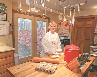 Ellen Conrad stands in the kitchen of her home in Salem. She runs a cooking school and teaches the entire spectrum of dining delights.