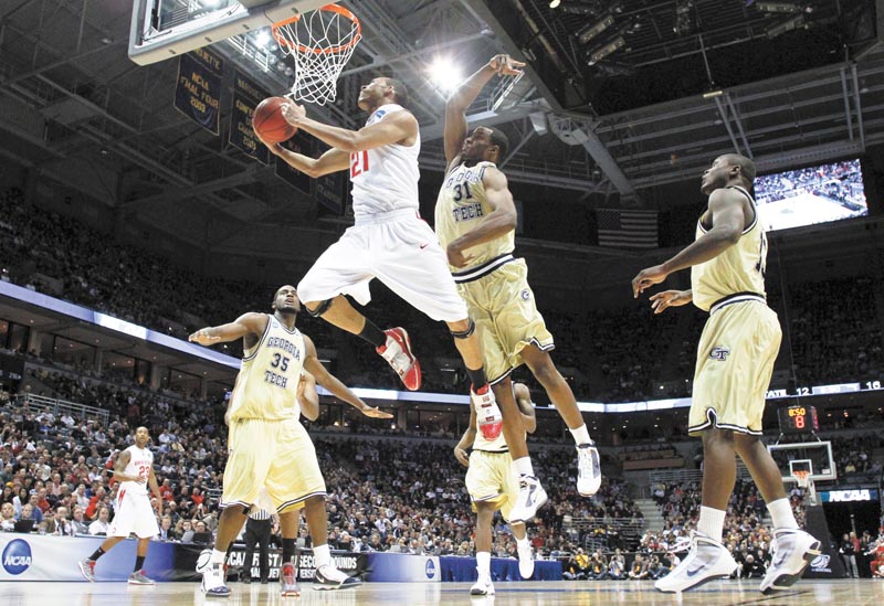 Ohio State's Evan Turner (21) goes for a basket against Georgia Tech's Zachery Peacock (35), Gani Lawal (31) and D'Andre Bell, right, in the first half of an NCAA second-round college basketball tournament game in Milwaukee, Sunday, March 21, 2010. (AP Photo/Jeffrey Phelps)