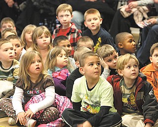 Kindergarten students from Poland’s elementary schools await Baby T. Rex, one of 17 life-size dinosaurs that will storm the Covelli Centre on May 4-5 at the “Walking with Dinosaurs” show.