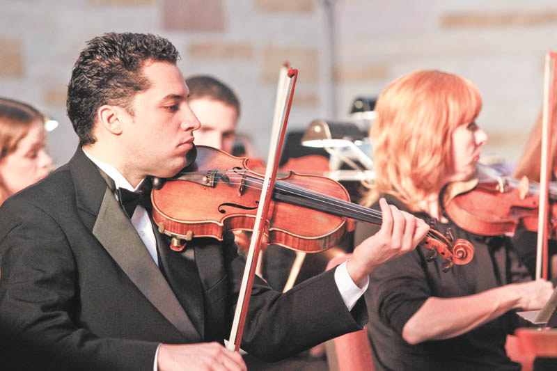 Alejandro Kamayd of Akron plays violin on stage at Christ Episcopal Church in Warren for the Warren Philharmonic Orchestra during a performance on Sunday, November 22, 2009.