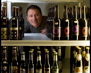 The Vindicator/Geoffrey Hauschild.2.2.2010.President of Vintage Estate, Phil Reda, poses for a portait on Tuesday afternoon behind some of the 760 beers available at Vintage Estate along South Ave. in Boardman. The company was rated the number one beer retailer in the world by the web site www.ratebeer.com.