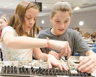 Liberty sixth-graders Isabella Nunu, 12, left, and Courtney Weimer, 11, take apart a computer keyboard during Tear Apart a Toaster Thursday at Youngstown State University’s Moser Hall. YSU’s Society of Women Engineers arranged the event.