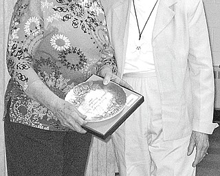 The Vindicator: During the March 11 meeting of Hubbard Historical Society, a Wendell August Forge commemorative plate was presented to, at left, Cecilia Cooper, society president, in recognition of her work and dedicated service to the organization. Sharing the moment with the honoree is Tess Hickey, who made the presentation.