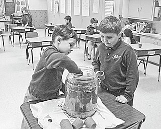 The Vindicator: Pupils in Elaine Scott’s first-grade class at St. Patrick School in Hubbard have been looking forward to spring as they studied about the environment and have become interested in Earth Day. Among the youngsters who are planting seeds to surprise their moms with gifts of gold (marigolds) this spring are, from left, Michael Anderson and Jeffery Hazy.