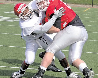 Vance Gibbs tries to stop David Rogers from gaining yards Saturday afternoon.