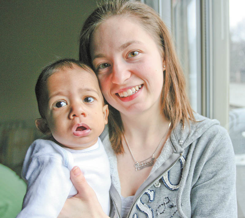 Caleb Machel is not too certain about the camera pointed his way, but his mother, Ashley Machel of Struthers, is all smiles. Caleb, nearly 8 months, appears to be fully recovered from lifesaving open-heart surgery performed when he was 6 days old.