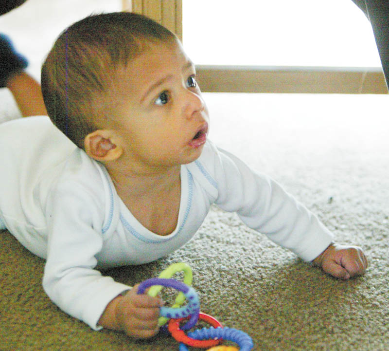 Caleb is on the verge of crawling.
