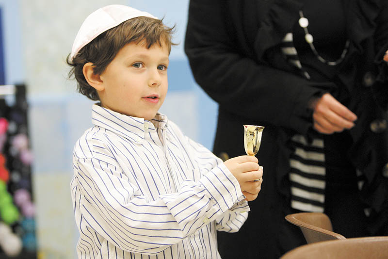 Dylan Shapiro, 5, holds a cup of grape juice, which is part of the order of the Seder. The ritual meal, which took place for Akiva Academy students, involves drinking four cups of grape juice or wine, which symbolize four of God’s promises of freedom to the Jewish people. Wine is a symbol of joy.