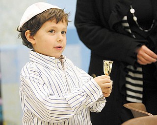 Dylan Shapiro, 5, holds a cup of grape juice, which is part of the order of the Seder. The ritual meal, which took place for Akiva Academy students, involves drinking four cups of grape juice or wine, which symbolize four of God’s promises of freedom to the Jewish people. Wine is a symbol of joy.