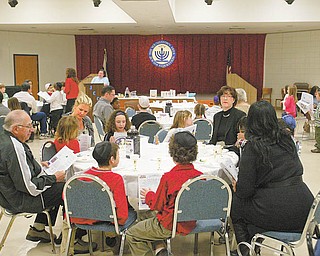 Students of Akiva Academy in Youngstown and teachers and family members gather for a model Seder 2at the Jewish Community Center. Susan Schonberger led the ritual meal for Passover.